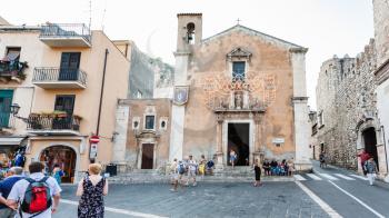 TAORMINA, ITALY - JULY 2, 2011: people near Church Of Saint Catherine Of Alexandria on Piazza Badia in Taormina city. Church of St Catherine was built the first half of 1600 on the ruins of the Odeon