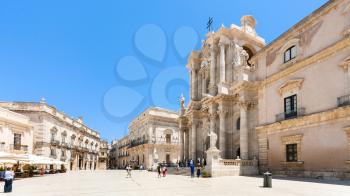 SYRACUSE, ITALY - JULY 3, 2011: tourists near Cathedral on piazza Duomo in Syracuse city in Sicily. The city is a historic town in Sicily, the capital of the province of Syracuse.