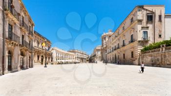 SYRACUSE, ITALY - JULY 3, 2011: tourists on piazza Duomo in Syracuse city in Sicily. The city is a historic town in Sicily, the capital of the province of Syracuse.