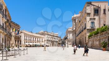 SYRACUSE, ITALY - JULY 3, 2011: tourists on main square piazza Duomo in Syracuse city in Sicily. The city is a historic town in Sicily, the capital of the province of Syracuse.