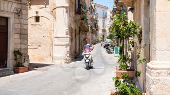 SYRACUSE, ITALY - JULY 3, 2011: scooter on street via Roma in Syracuse city in Sicily. The city is a historic town in Sicily, the capital of the province of Syracuse.