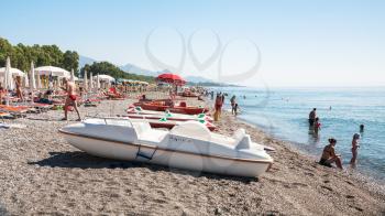 FLUMEFREDDO DI SICILIA, ITALY - JULY 2, 2011: boats and people on beach spiaggia di Marina di Cottone on Ionian Sea coast in Sicily. This beach is subject to very intense summer tourism.