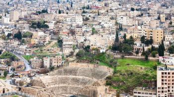 Travel to Middle East country Kingdom of Jordan - above view of ancient Roman Theater in Amman city from citadel in winter