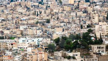 Travel to Middle East country Kingdom of Jordan - view of apartment houses in Amman city from citadel in winter