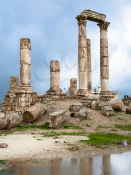 Travel to Middle East country Kingdom of Jordan - view of Temple of Hercules at Amman Citadel in rainy day in winter