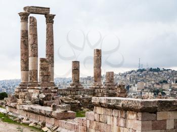 Travel to Middle East country Kingdom of Jordan - view of Temple of Hercules at Amman Citadel and Amman city in rainy day in winter