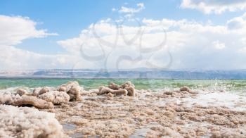 Travel to Middle East country Kingdom of Jordan - crystalline surface of Dead Sea coast in winter