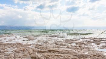 Travel to Middle East country Kingdom of Jordan - crystalline surface of Dead Sea shore in winter
