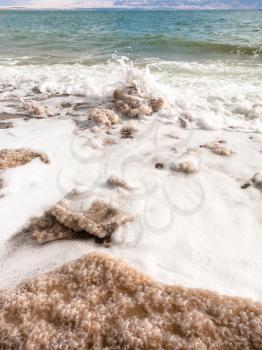 Travel to Middle East country Kingdom of Jordan - pieces of crystalline salt on coast of Dead Sea in winter