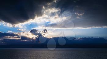Travel to Middle East country Kingdom of Jordan - sundown in dark blue clouds over Dead Sea in winter evening
