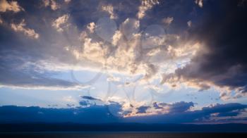 Travel to Middle East country Kingdom of Jordan - blue sunset clouds over Dead Sea in winter evening