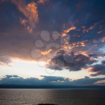 Travel to Middle East country Kingdom of Jordan - red and blue sunset clouds over Dead Sea in winter evening