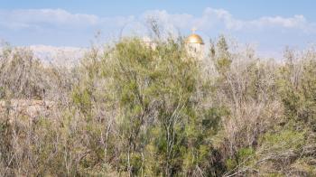 Travel to Middle East country Kingdom of Jordan - dome of Greek Orthodox Church of John the Baptist in Holy Land near Baptism Site Bethany Beyond the Jordan (Al-Maghtas) in sunny winter day
