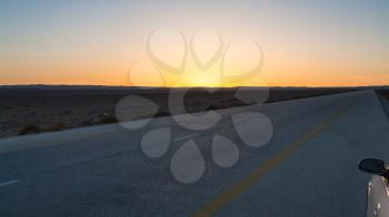 Travel to Middle East country Kingdom of Jordan - sunset over Desert Highway (Road 15) in Jordan in winter