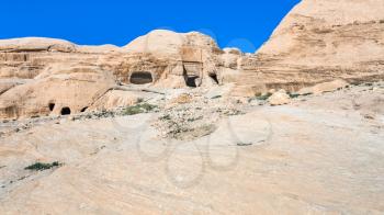 Travel to Middle East country Kingdom of Jordan - ancient tombs and caves at Bab as-Siq road to Petra town in winter