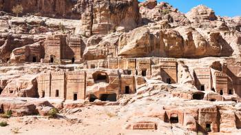 Travel to Middle East country Kingdom of Jordan - ancient tombs and houses on Street of Facades in city Petra in winter