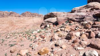 Travel to Middle East country Kingdom of Jordan - sandstone rocks in desert landscape in Petra town