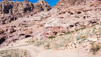 Travel to Middle East country Kingdom of Jordan - path along ancient caves in Petra town in winter