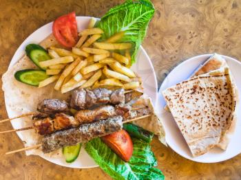 Travel to Middle East country Kingdom of Jordan - portion of various arabian kebabs in restaurant in Petra town