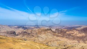 Travel to Middle East country Kingdom of Jordan - blue sky over mountain around Wadi Araba (Arabah, Arava, Aravah) area near Petra town in sunny winter day