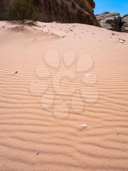 Travel to Middle East country Kingdom of Jordan - red sand dune in Wadi Rum desert in sunny winter day