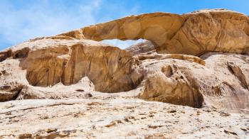 Travel to Middle East country Kingdom of Jordan - bridge rock in Wadi Rum desert in sunny winter day