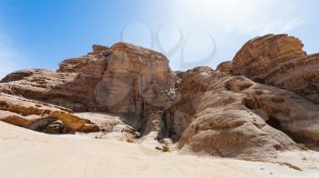 Travel to Middle East country Kingdom of Jordan - old rocks in Wadi Rum desert in sunny winter day