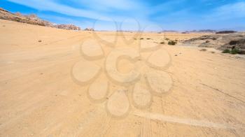 Travel to Middle East country Kingdom of Jordan - road in Wadi Rum desert in sunny winter day
