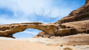 Travel to Middle East country Kingdom of Jordan - view of bridge sandstone mount in Wadi Rum desert in sunny winter day