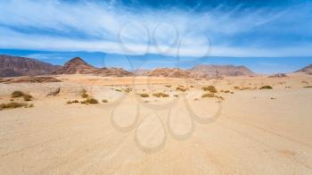 Travel to Middle East country Kingdom of Jordan - road in sand of Wadi Rum desert in sunny winter day