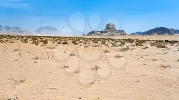 Travel to Middle East country Kingdom of Jordan - view of Sphinx rock in Wadi Rum desert in sunny winter day