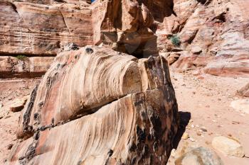 Travel to Middle East country Kingdom of Jordan - sandstone rock on street in Petra town
