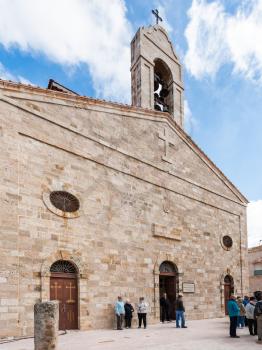 MADABA, JORDAN - FEBRUARY,20, 2012: tourists near Greek Orthodox Basilica of St George. Madaba city is known by its Byzantine and Umayyad mosaics, especially the mosaic map of Holy Land in this Church
