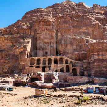 PETRA, JORDAN - FEBRUARY 21, 2012: bedouin camp and Royal Urn Tomb in ancient Petra town. Rock-cut town Petra was established about 312 BC as the capital city of the Arab Nabataean