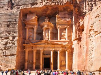 PETRA, JORDAN - FEBRUARY 21, 2012: people on plaza near al-Khazneh temple (The Treasury) in ancient Petra. Rock-cut town Petra was established about 312 BC as the capital city of the Arab Nabataean
