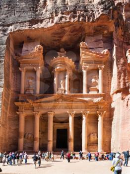 PETRA, JORDAN - FEBRUARY 21, 2012: people on plaza of al-Khazneh temple (The Treasury) in Petra city. Rock-cut town Petra was established about 312 BC as the capital city of the Arab Nabataean