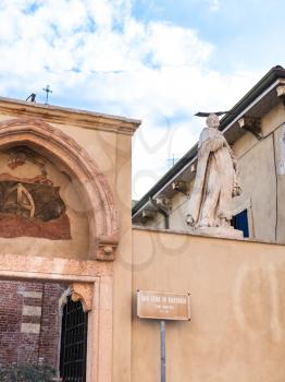 travel to Italy - statue of Saint on walls of Church of San Zeno in Oratorio (Chiesa di San Zenetto) in Verona city