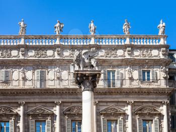 travel to Italy - marble column topped by a winged lion, the symbol of Venice, in front of palazzo maffei on Piazza delle Erbe (Market's square) in Verona city in spring