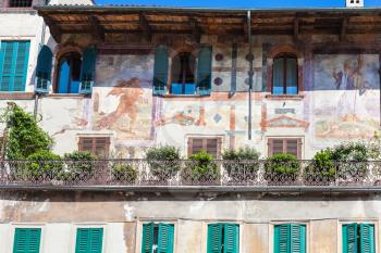 travel to Italy - medieval frescoes of facade urban house (Case Mazzanti) on Piazza delle Erbe (Market's square) in Verona city in spring