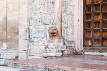 travel to Italy - lion statue near doors of Basilica di San Zeno ( San Zeno Maggiore, San Zenone) in Verona city in spring