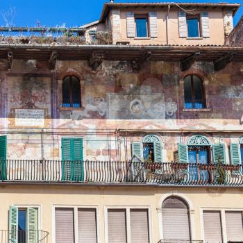travel to Italy - medieval paintings of facade urban house (Case Mazzanti) on Piazza delle Erbe (Market's square) in Verona city in spring