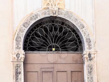 travel to Italy - door of medieval palazzo on street contra porti in Vicenza city in spring.