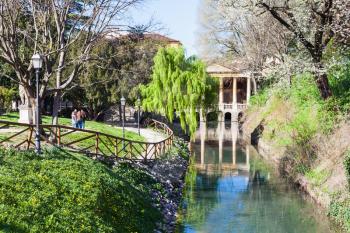 travel to Italy - view of urban public park Giardini Salvi (Garden of Valmarana Salvi) with Valmarana Loggia at canal of Seriola river in Vicenza city in spring