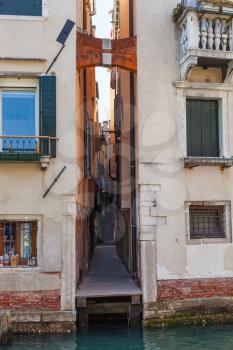 travel to Italy - narrow street Calle del Magazen from waterfront of Rio de la Pieta canal in Venice city in spring