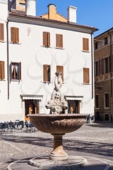 travel to Italy - fountain (Fontana dei delfini) on Piazza Broletto in Mantua city in spring
