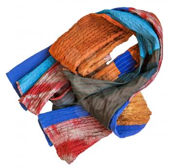 folded stitched patchwork scarf from batik and painted silk fabric pieces isolated on white background