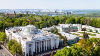 travel to Ukraine - view of Verkhovna Rada building (Supreme Council of Ukraine) on Hrushevskiy street, Mariyinsky palace in Mariinsky park and Dnieper Riveron horizon in Kyiv city in spring