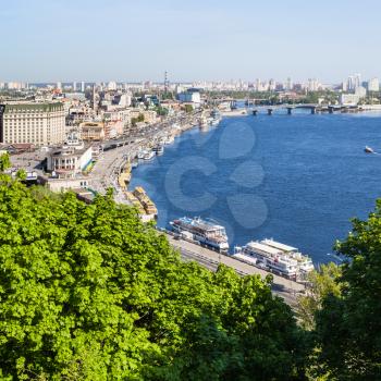 travel to Ukraine - view of Kiev city Podil District with River Port and Dnieper River from Volodymyrska Hill (Saint Volodymyr Hill) in spring