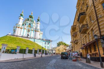 KIEV, UKRAINE - MAY 5, 2017: people and view of St Andrew's Church from Andriyivskyy Descent in Kiev city in spring. The church was constructed in 1747-1754 by architect Bartolomeo Rastrelli