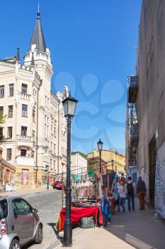 KIEV, UKRAINE - MAY 5, 2017: tourists near gift shops on Andriyivskyy Descent in Kiev city in spring. This street connecting Upper Town district and the historical commercial Podil district